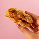 Inside view of Biscoff White Choco Chip Cookie showing gooey Biscoff spread and white chocolate chunks