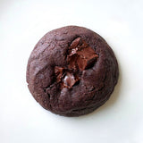 Close-up of a single Choco Brownie Cookie highlighting gooey melted chocolate chunks.