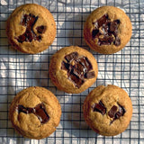 Five chocolate chip cookies are on a cooling rack against a light background. Shop online in India