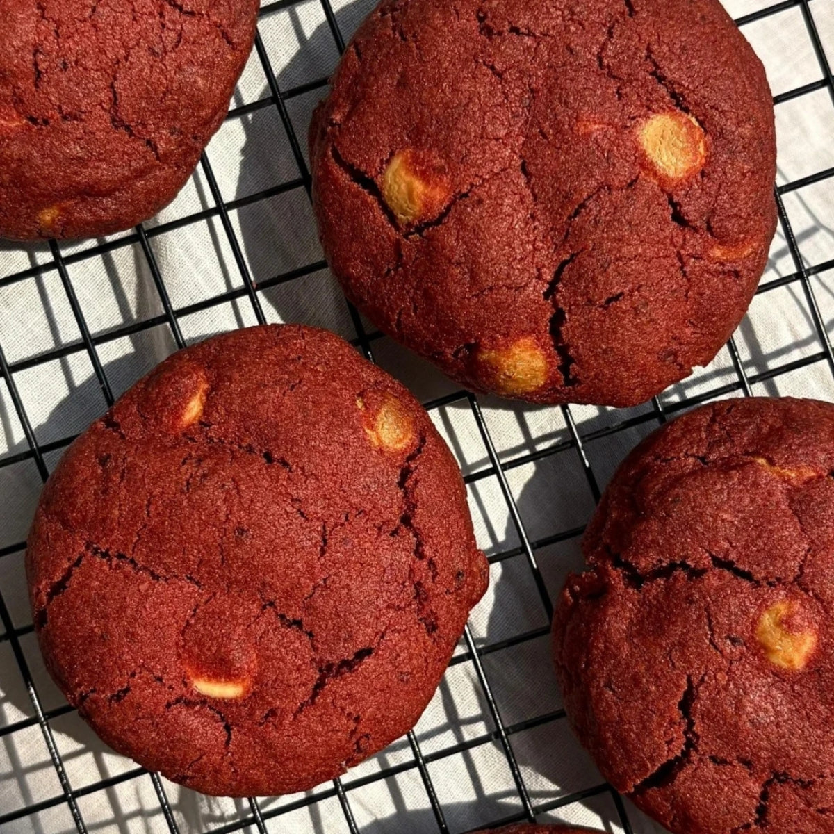 Freshly baked Red Velvet Cream Cheese Cookies with creamy filling, premium eggless handmade cookies by Queen Cookies