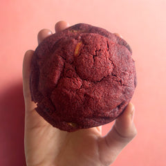 Eggless red velvet cream cheese cookie held in hand, baked by Queen Cookies, Mumbai