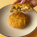 Close-up of eggless saffron pistachio dry fruit cookie broken in half, best for online purchase in India from Queen Cookies